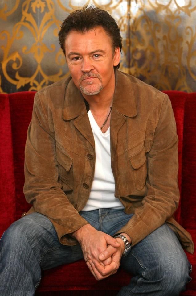 Paul Young, pop star, seated.