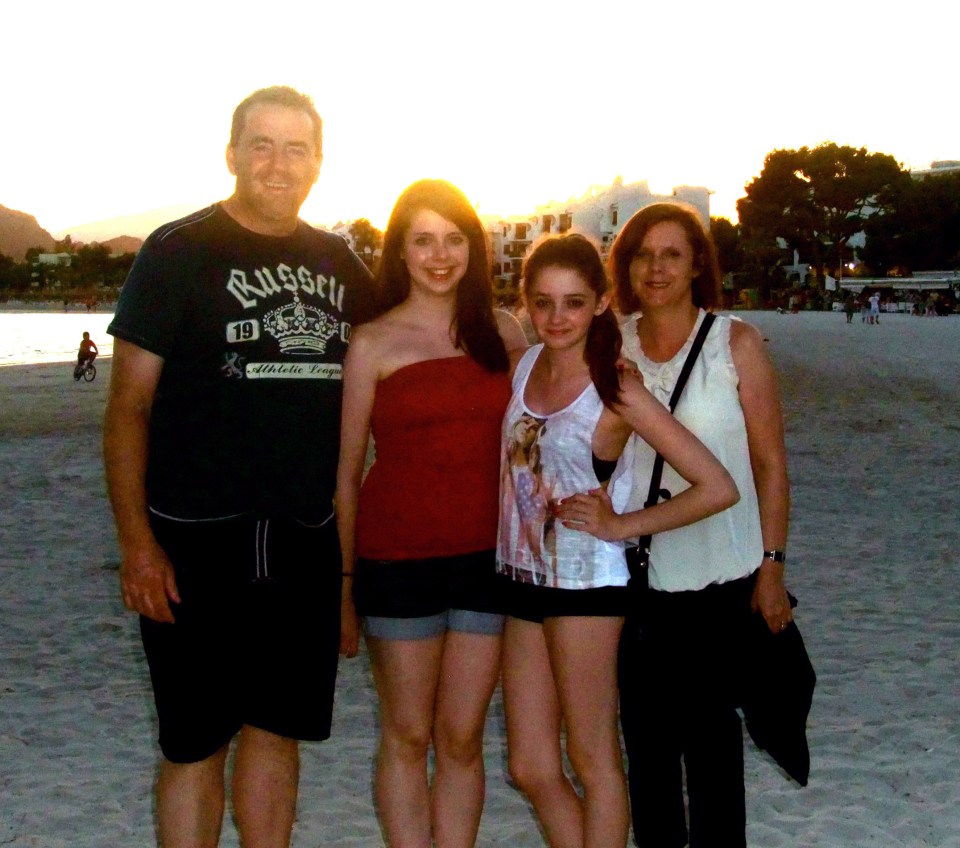 Photo of a family on a beach at sunset.