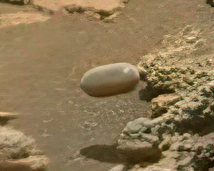 Mars surface with Tic Tac-shaped object.