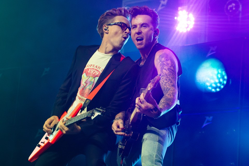 Tom Fletcher and Danny Jones of McFly performing on stage.